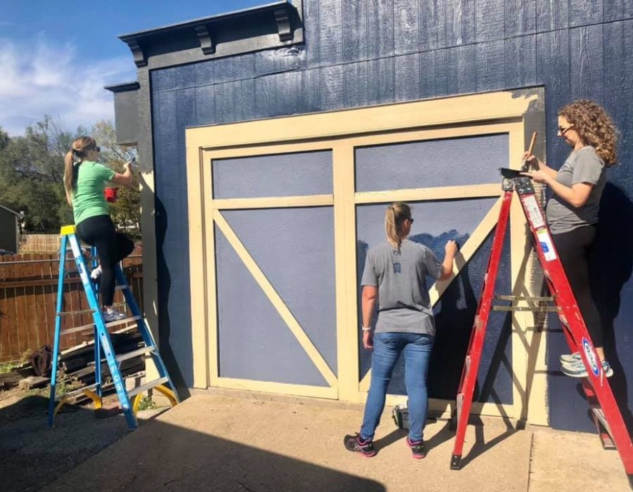 Painting around the campus at the Freedom for Youth Volunteer Day for the Foster Group Team